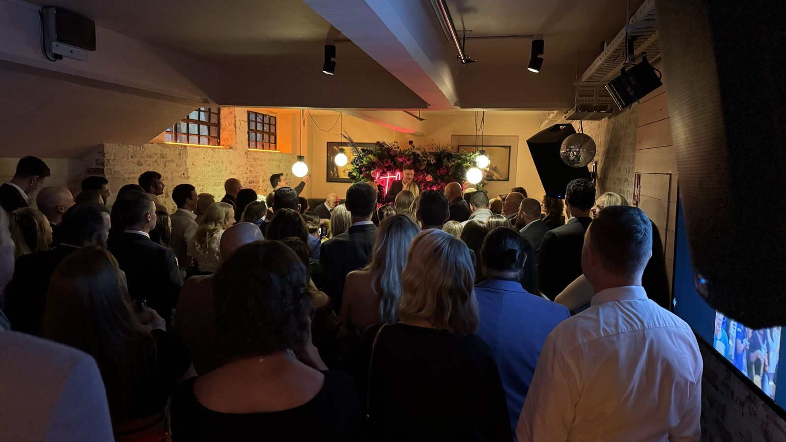 Guests filling the dancefloor at an indoor wedding reception