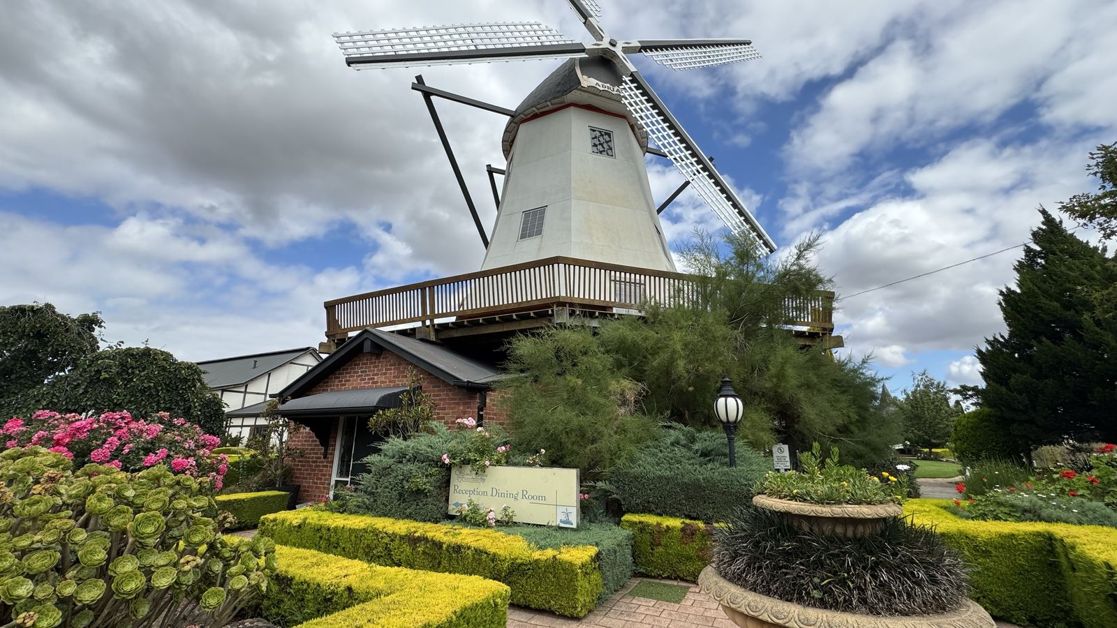 Garden wedding venue with historic windmill backdrop
