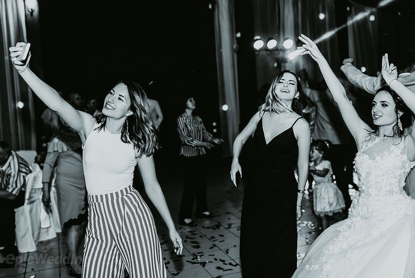 Guests dancing mid-celebration, black and white