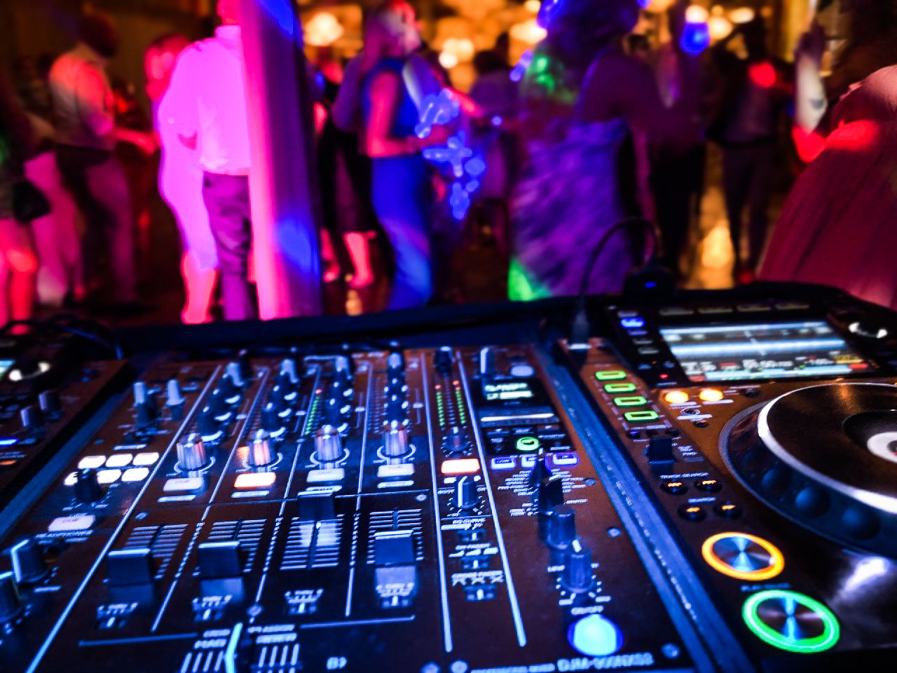 DJ mixer close-up with colourful performance pads