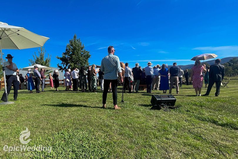 Guests enjoying lawn games at an outdoor wedding reception