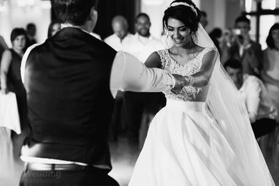Bride and groom sharing their first dance, black and white
