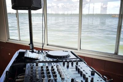 DJ mixer set up by the window at a waterfront venue